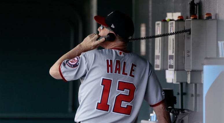 Nationals bullpen coach Chip Hale makes a call to the bullpen in the Colorado series A kingdom for a Nationals reliever