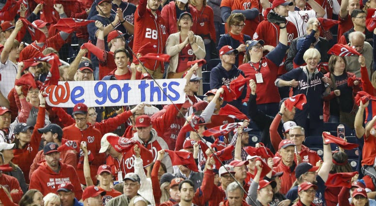 Nats fans... get ready for Games 3 and 4 (and maybe 5) at home. Nationals fans hold a sign during the first inning of Game 3 of the NLCS.