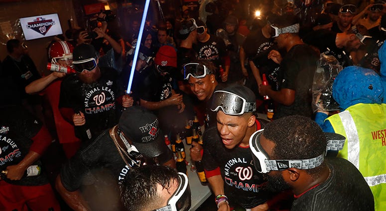 Sean Doolittle breaks out the lightsaber as the Nationals celebrate winning the NL pennant with champagne in the clubhouse Nationals win National League pennant
