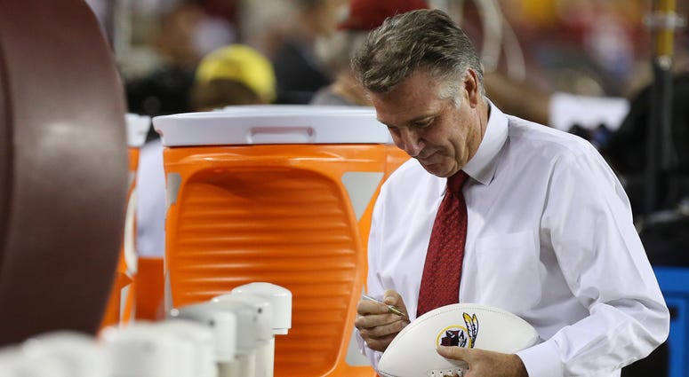 Redskins president Bruce Allen signs an autograph prior to a Sept. 2017 game against the Raiders Bruce Allen overestimates Redskins' worth