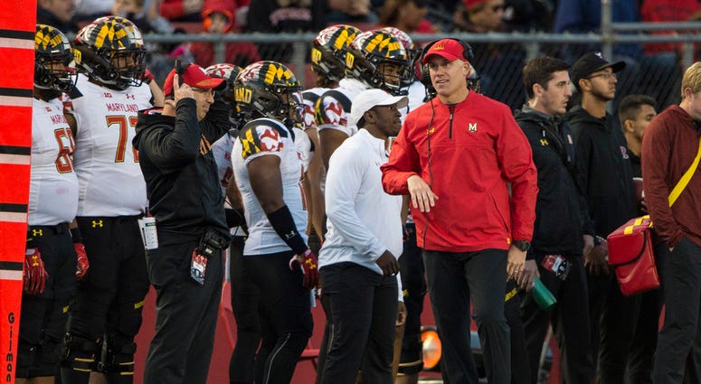 Maryland coach DJ Durkin and players standing on the sideline. DJ_Durkin_Maryland