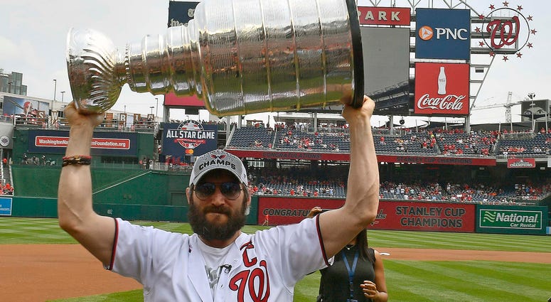 Alex Ovechkin celebrates with the Stanley Cup at a Nationals game alex_ovechkin_caps_nats