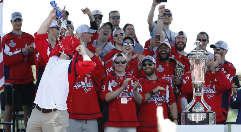 Capitals forward T.J. Oshie chugs beer at Caps Cup parade. Redskins Ryan Kerrigan honors T.J. Oshie with beer chug at Game 5.