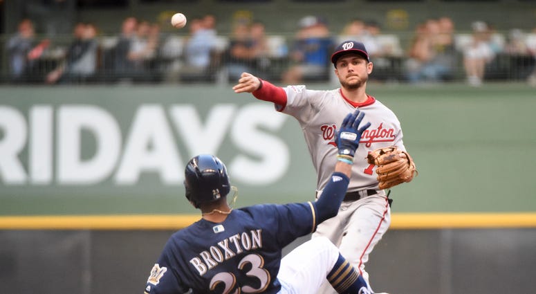 Trea Turner turns a double play against the Milwaukee Brewers. Trea_Turner_Brewers
