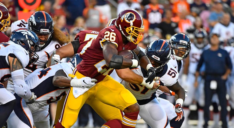 Adrian Peterson rumbles past the Broncos defense Adrian_Peterson_Redskins