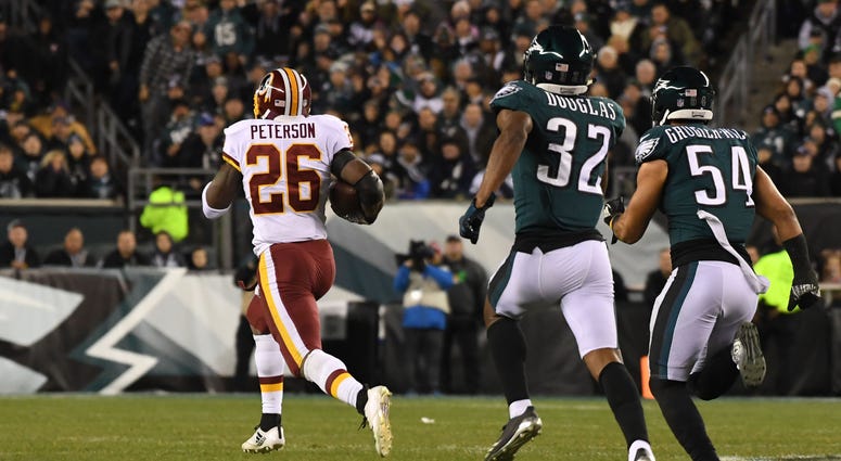 Adrian Peterson gallops for a 90-yard touchdown against the Eagles in December Adrian Peterson returns to Redskins on two-year deal
