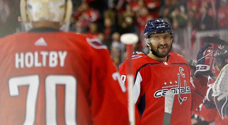 Alex Ovechkin celebrates after scoring a hat trick against the Red Wings