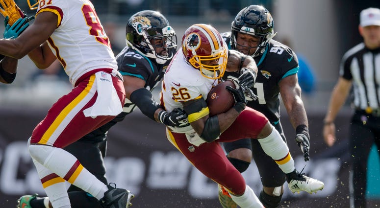 Adrian Peterson carries the ball for the Washington Redskins. Adrian_Peterson_Jaguars