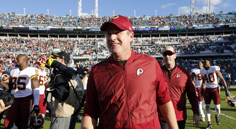 Jay Gruden smiles as he leaves the field after a 16-13 Redskins win over the Jaguars Jay Gruden told he'll be back as Redskins coach in 2019