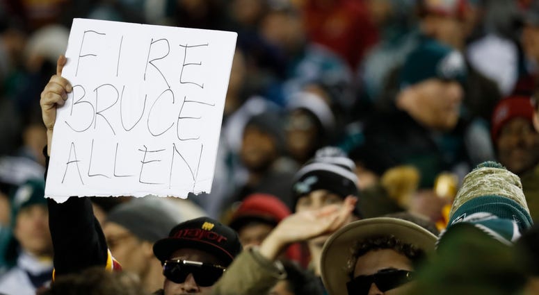 A Redskins fan holds up a "Fire Bruce Allen" sign. Fire_Bruce_Allen_Sign