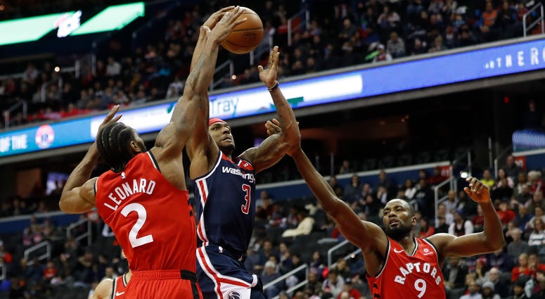 Bradley Beal shoots over the Raptors' Kawhi Leonard and Serge Ibaka. Bradley_Beal_Wizards_Raptors