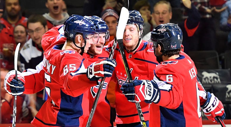Nic Dowd celebrates a first-period goal with teammates as the Caps return to action against Calgary As 'mental exhaustion' subsides, Caps know how to get back on track