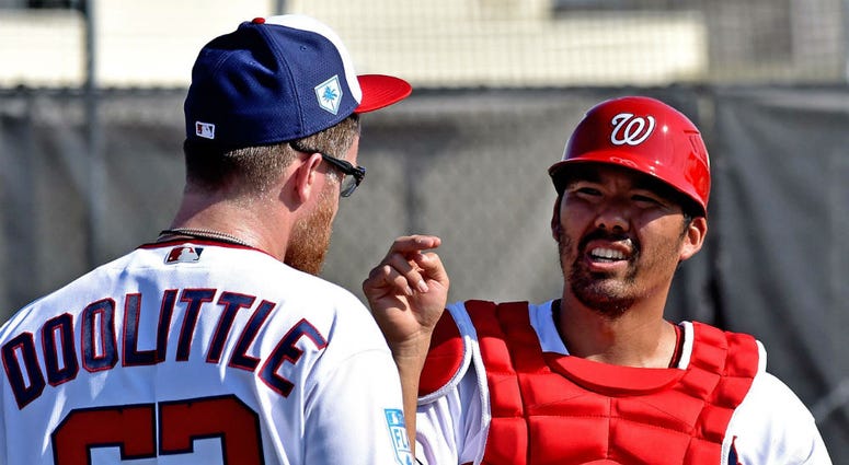 Washington Nationals catcher Kurt Suzuki talks with Sean Doolittle. Nationals catcher Kurt Suzuki has no problem splitting time with Yan Gomes.