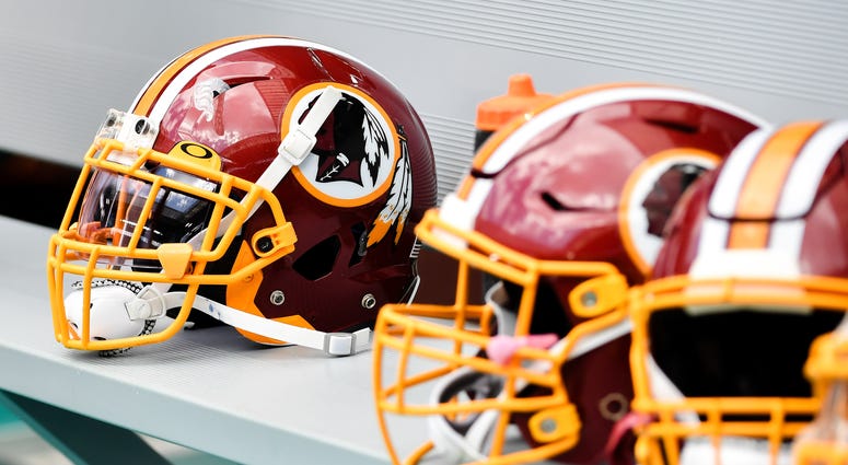 Correction to report on Bruce Allen's role in Redskins replay review. Washington Redskins helmets are seen on the bench against the Miami Dolphins.