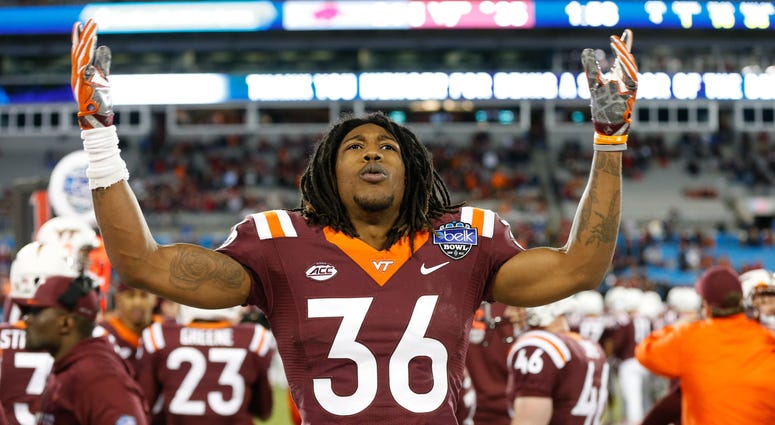 Adonis Alexander celebrates on the sideline at the Belk Bowl in 2016 Adonis_Alexander_Redskins