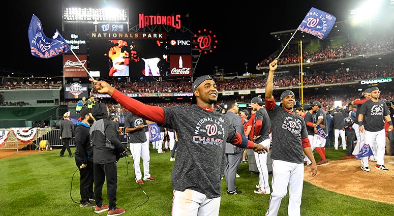 Victor Robles and Juan Soto wave pennants signifying the Nats winning the National League pennant Victor Robles Juan Soto Pennant