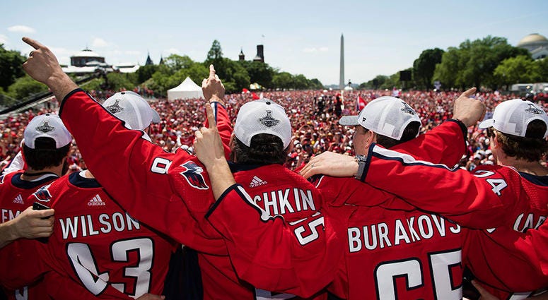 CITY OF RED: Your 2018 Stanley Cup Champions The Capitals embrace in front of 500,000 fans on the National Mall.