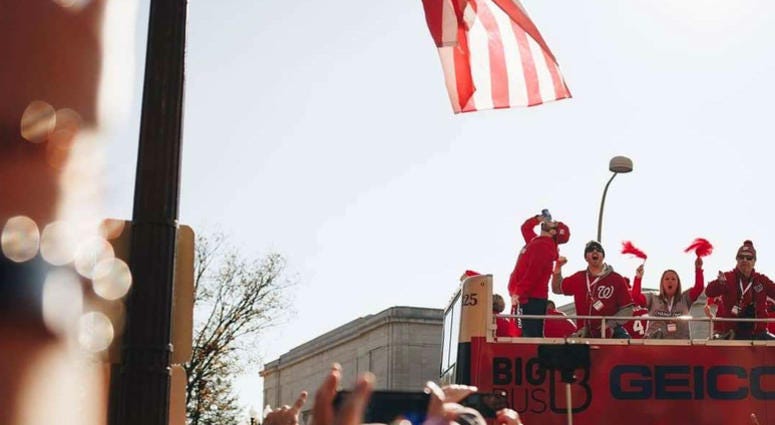 That's Grant. On top of a parade bus, drinking a cold one. Grant Paulsen and Danny Rouhier of the "Grant & Danny Show" take part in the Washington Nationals victory parade in Washington, D.C. on Saturday, November 1.