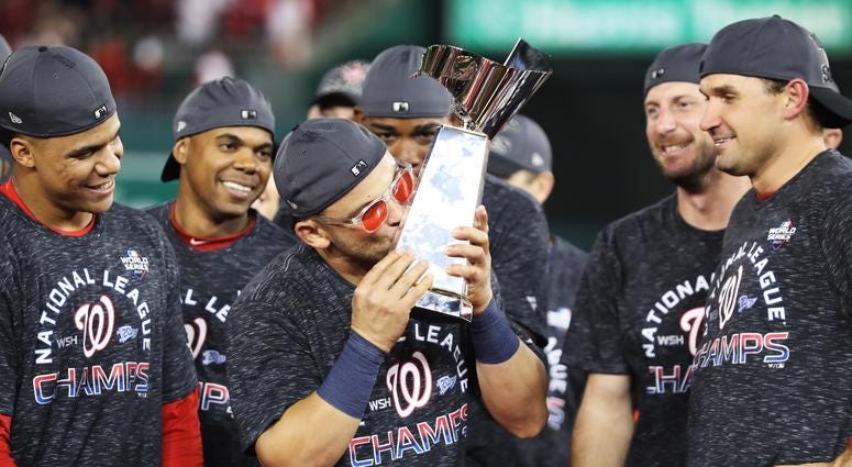A Baby Shark kiss after sweeping Cardinals in the NLCS. Gerardo Parra celebrates with the trophy after Nationals win Game 4 of the NLCS.