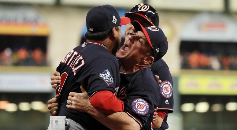 Bob Henley helps hold back Davey Martinez. Best pictures of World Series umpire controversy, Dave Martinez ejection