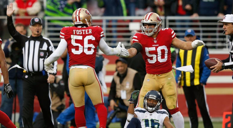 Reuben Foster and Brock Coyle celebrate after tackling Tyler Lockett. Reuben_Foster_49ers