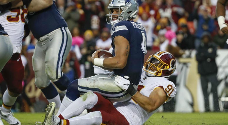 Redskins linebacker Ryan Kerrigan (91) sacks Dallas Cowboys quarterback Dak Prescott (4) during the second half of an NFL football game, Sunday, Oct. 21, 2018 in Landover, Md. Ryan_Kerrigan_Strip_Sack