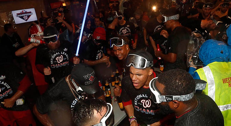 Sean Doolittle breaks out the lightsaber as the Nationals celebrate winning the NL pennant with champagne in the clubhouse Nationals win National League pennant