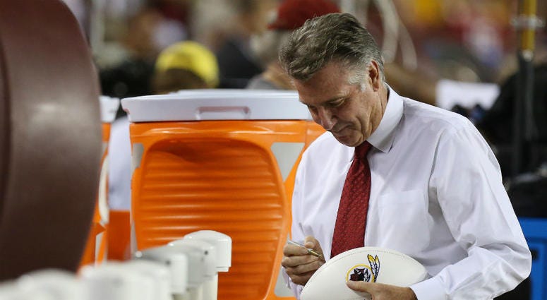 Redskins team president Bruce Allen signs a football. Bruce_Allen_Redskins