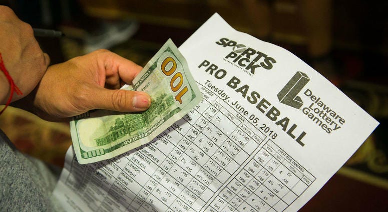 A gambler looks over odds before placing a wager on baseball. Sports_Gambling_Delaware