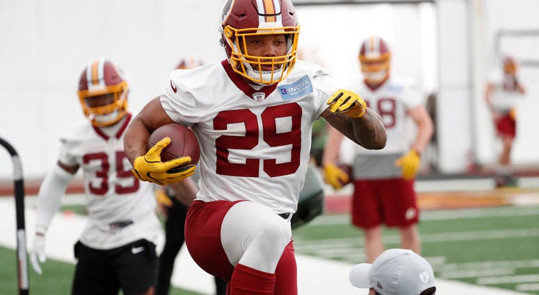 Guice leaps over an assistant at Redskins minicamp Derrius_Guice_Redskins