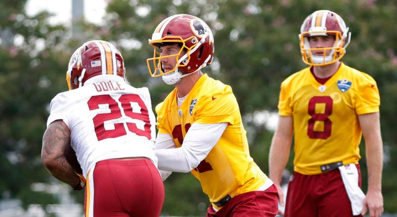 Guice take the hand-off from Redskins QB Alex Smith in training camp Derrius_Guice_Training_Camp