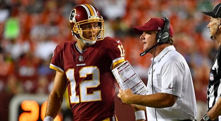 Colt McCoy and Jay Gruden talk on the sideline. Schedule gives Redskins veteran QBs edge over potential rookie replacement.