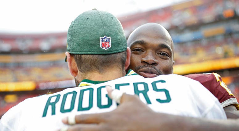 Adrian Peterson and Aaron Rodgers embrace after a game. Adrian_Peterson_Aaron_Rodgers