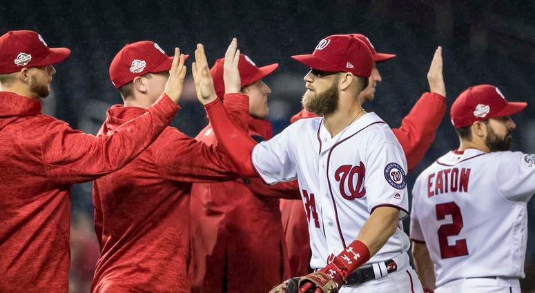 Bryce Harper high fives teammates after a win. Bryce_Harper