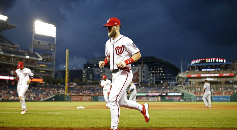 Bryce Harper walks off the field at Nats Park. Bryce Harper's long hold out will likely net him a bigger contract.