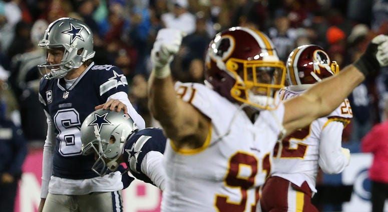 Cowboys kicker Brett Maher is consoled by holder Chris Jones (6) after missing a game-tying field goal attempt on the final play of the fourth quarter, as Redskins linebacker Ryan Kerrigan (91) celebrates. Ryan_Kerrigan_Brett_Maher