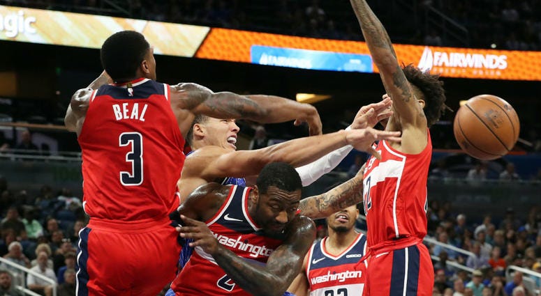 Washington Wizards players fight for a rebound. Washington_Wizards_Wall