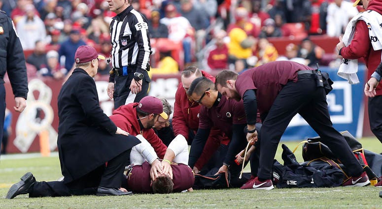 Redskins trainers attend to Alex Smith. Alex_Smith_Texans