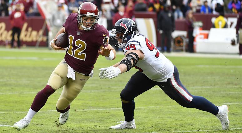 Colt McCoy tries to avoid the tackle of J.J. Watt. Colt_McCoy_Texans