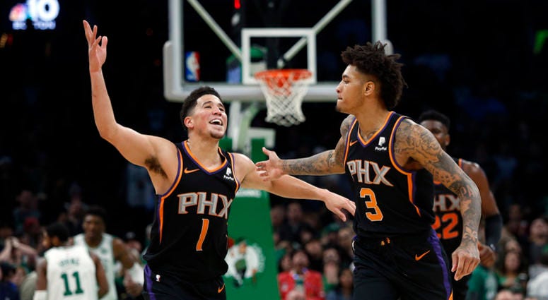 Kelly Oubre celebrates with new Suns teammate Devin Booker Let's all just agree to never talk about the Kelly Oubre trade again