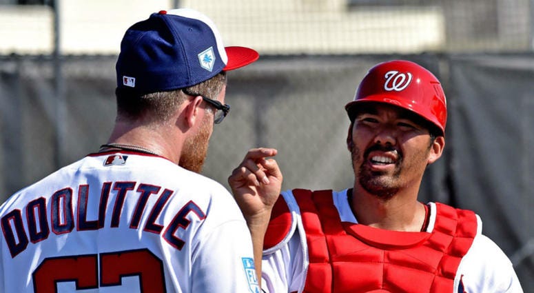 Washington Nationals catcher Kurt Suzuki talks with Sean Doolittle. Nationals catcher Kurt Suzuki has no problem splitting time with Yan Gomes.