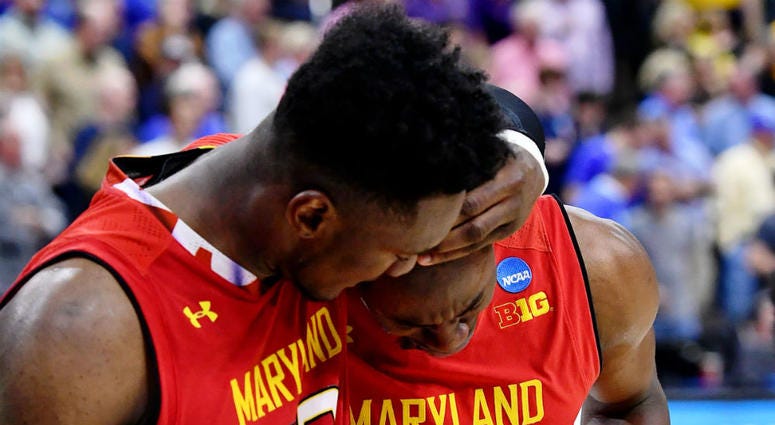 Terps forward Bruno Fernando consoles Jalen Smith after their loss to LSU. Did LSU get away with a travel to beat Maryland in March Madness?