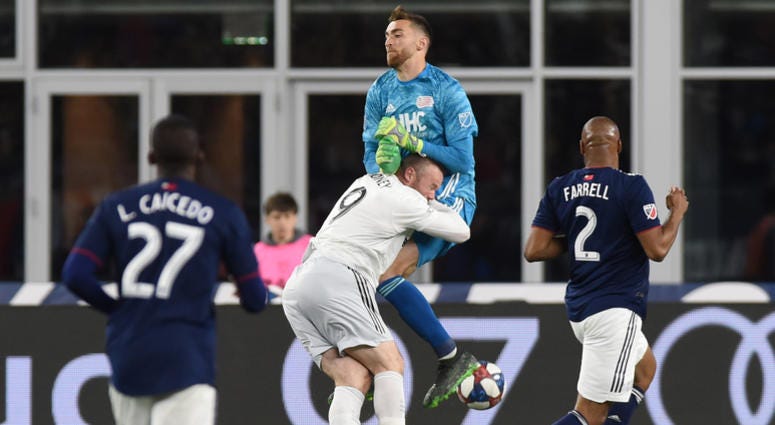 Wayne Rooney collides with Revolution goalkeeper Matt Turner. Wayne_Rooney