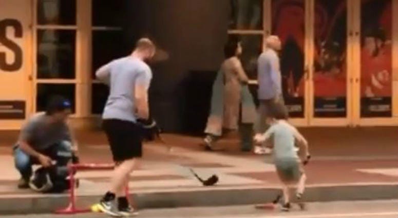 A father plays street hockey with his son in the shadows of Capital One Arena Father_Son_Street_Hockey