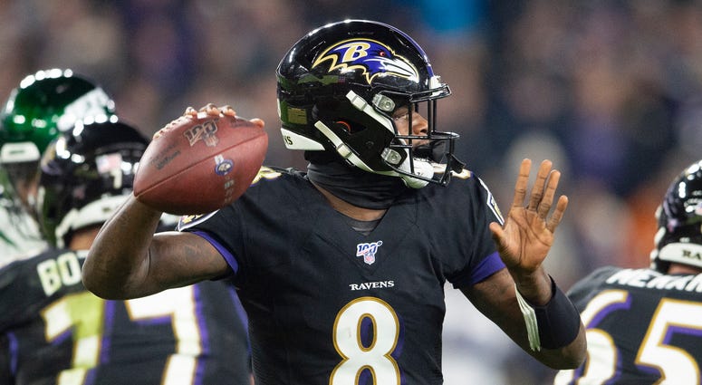 Lamar Jackson throws a TD pass in the third quarter in a 42-21 win over the Jets.
