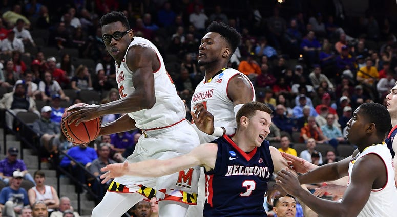 Mar 21, 2019; Jacksonville, FL, USA; Maryland Terrapins forward Jalen Smith (left) grabs a rebound against forward Bruno Fernando (middle) and Belmont Bruins guard Dylan Windler (3) during the second half in the first round of the 2019 NCAA Tournament at