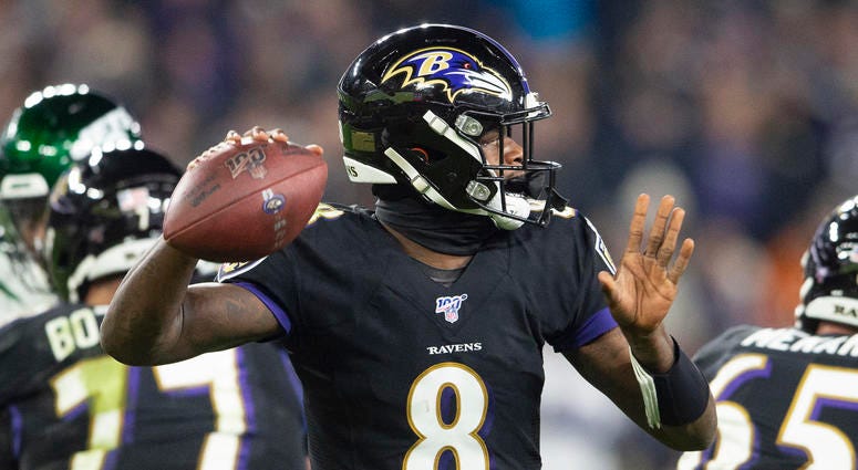 Lamar Jackson throws a TD pass in the third quarter in a 42-21 win over the Jets.