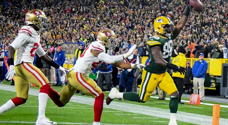 NFL: San Francisco 49ers at Green Bay Packers Oct 15, 2018; Green Bay, WI, USA; Green Bay Packers running back Ty Montgomery (88) scores a touchdown against San Francisco 49ers linebacker Fred Warner (48) in the first quarter at Lambeau Field. Mandatory Credit: Benny Sieu-USA TODAY Sports