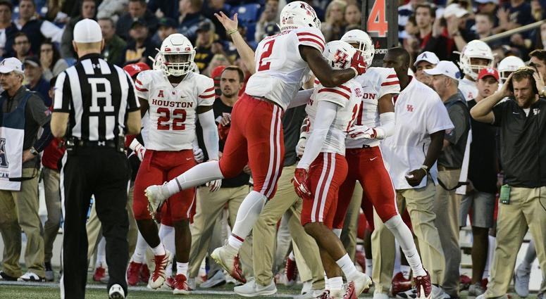 NCAA Football: Houston at Navy Oct 20, 2018; Annapolis, MD, USA; Houston Cougars defensive back Deontay Anderson (2), cornerback Alexander Myres (18) and defensive back Gleson Sprewell (21) celebrate after stopping Navy Midshipmen on fourth down during the fourth quarter at Navy-Marine