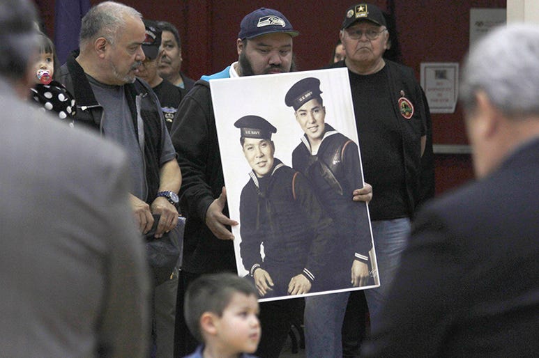 In this Monday, March 18, 2019 photo, family members of brothers Mark Jacobs Jr. and Harvey Jacobs observe a moment of silence during a ceremony honoring Tlingit code talkers in Juneau, Alaska. Five long-deceased Alaska Native servicemen are being hailed Alaskan_Tlingit_Native_Code_Talkers_World_War_II_2_AP_Newsroom